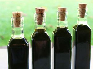 Homemade Nocino walnut liqueur in bottles with cork stoppers