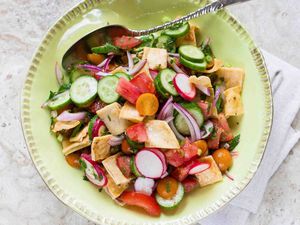 Fattoush with summer vegetables and pita chips in a round bowl