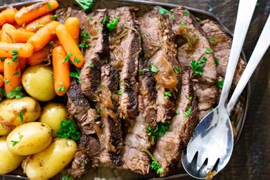 Instant Pot Pot Roast sliced and served on a platter with carrots and potatoes