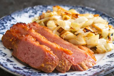 The best baked corned beef on a plate with some sauteed cabbage