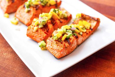 Grilled Salmon Fillet with Mango Salsa - grilled salmon portions on a plate with fresh salsa