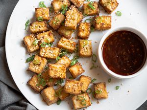 Crispy Air Fryer Tofu on a Plate Served with a Bowl of Sauce