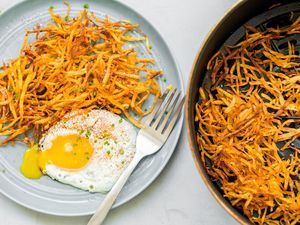 Air Fryer Hash Browns on a Plate with a Sunny Side Egg and in an Air Fryer Basin