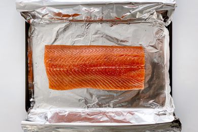 Unbaked salmon on a foil lined baking sheet to make Garlic Butter Baked Salmon.