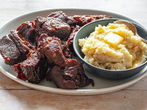 Braised Short Ribs with Root Beer BBQ Sauce on a Plate with a Bowl of Mashed Potatoes
