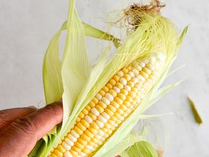 Hand Husking Corn for Cajun Corn Recipe