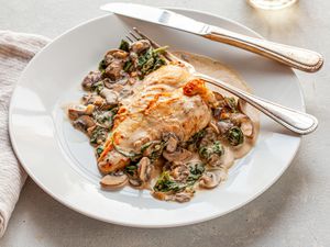 A plate of creamy chicken Florentine on a table 