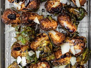 On a a Cooling Rack over a Baking Pan, Deep Fried Brussels Sprouts Topped with Shaved Parmesan and Balsamic Vinegar 