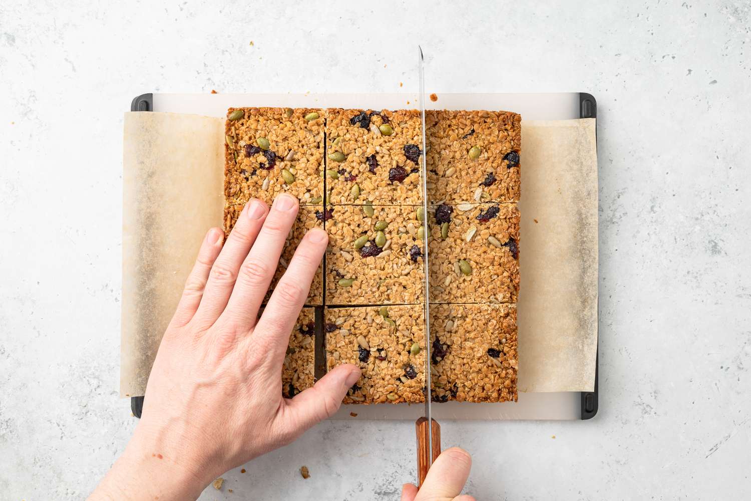 Flapjack Slab Cut Into Bars on a Parchment Paper Covered Cutting Board