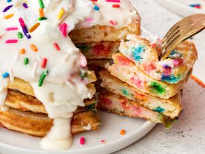 Slice of Stacked Funfetti Pancakes Removed From Plate With the Rest of the Pancake Using a Fork