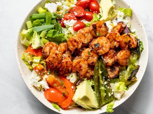 Bowl of Grilled Shrimp Salad with Shrimp, Avocados, Cherry Tomatoes, and Cotija Cheese