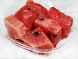 Pieces of watermelon in an open plastic to go container
