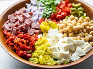 Large Bowl of Cheese, Peppers, Salami, Olives, Chickpeas, and Lettuce for Italian Chopped Salad 