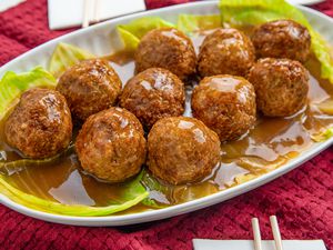 Lion's Head Meatballs Served on a Bed of Cabbage on a Platter