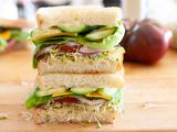 Loaded Veggie Sandwiches Stacked on a Cutting Board