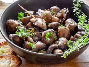 Marinated Mushrooms in a Bowl with Herbs