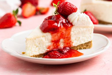No-bake cheesecake slice on a plate with strawberry sauce on top