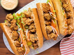 A Platter Filled with Oyster Po' Boys, Surrounded by a Kitchen Towel and a Bowl of Remoulade 