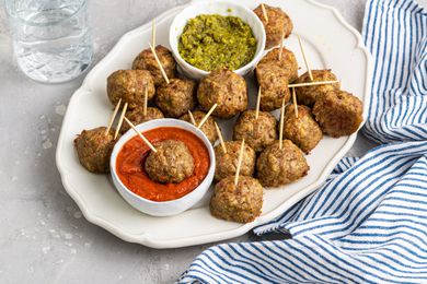 Plate of Pesto Meatballs with Two Bowls of Sauce (Pesto and Marinara)