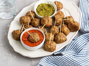 Plate of Pesto Meatballs with Two Bowls of Sauce (Pesto and Marinara)