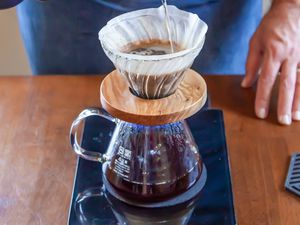 Water Poured onto Coffee Grounds in a Pour Over Device and Carafe