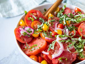 Bowl of Simple Summer Tomato Salad with a Serving Spoon 