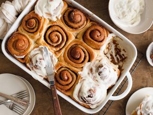 Sourdough Discard Cinnamon Rolls in a Casserole Dish with Some Glazed with Cream Cheese Frosting