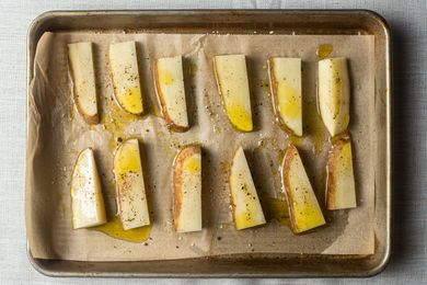 potatoes on parchment paper lined half sheet pan