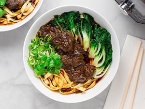 Bowl of Instant Pot Taiwanese Beef Noodle Soup Next to Instant Pot
