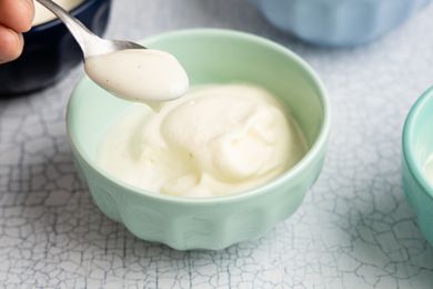 Easy Homemade Vanilla Pudding in Multiple Bowls with Some on a Spoon