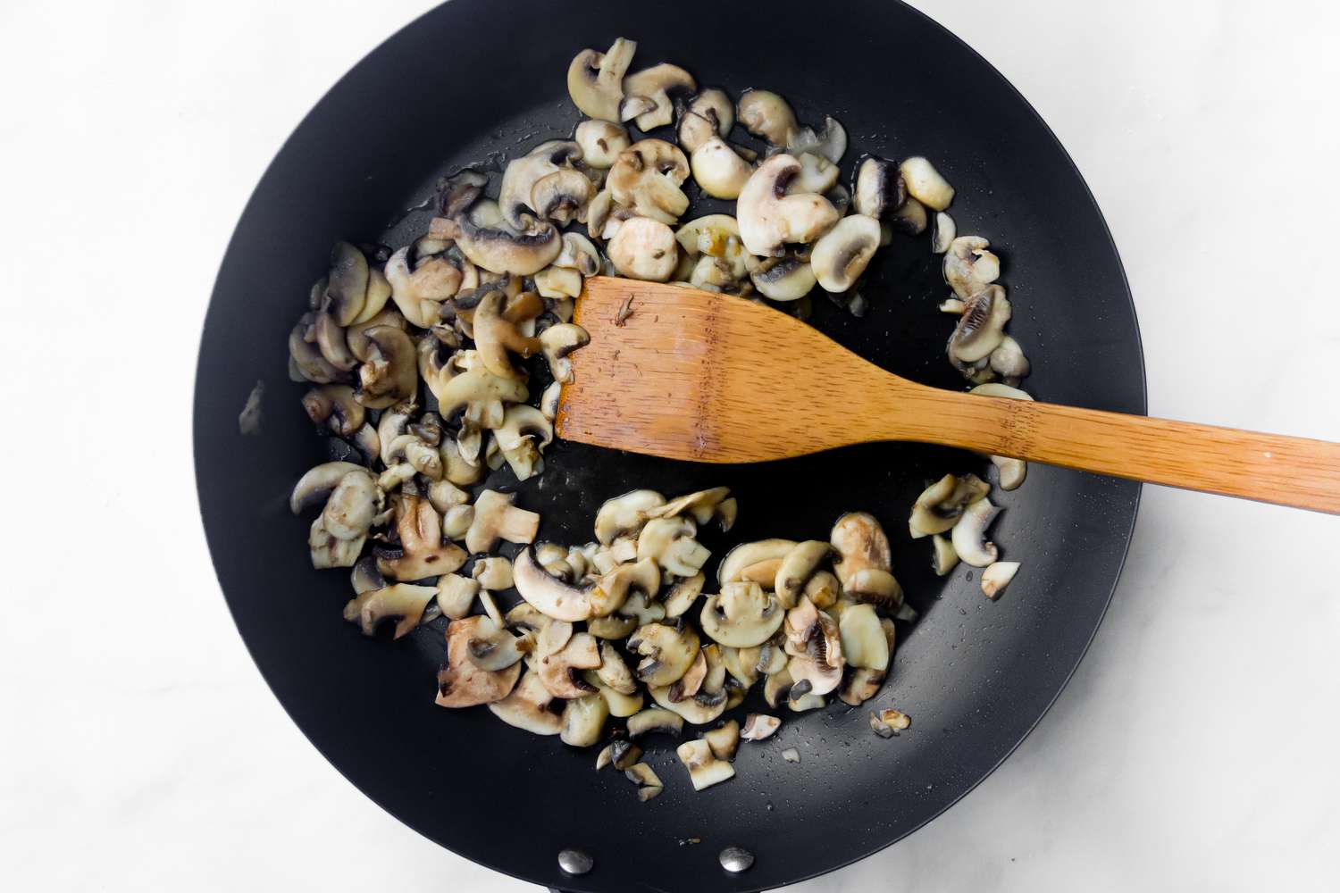 Cook mushrooms in a black skillet.
