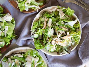 Overhead view of a table filled with bowls of quick chicken salad with tahini dressing