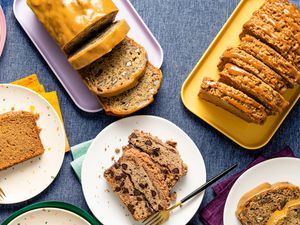 Four types of banana bread on platters and plates