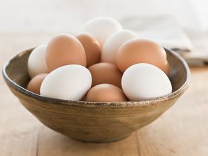 white and brown eggs in a bowl