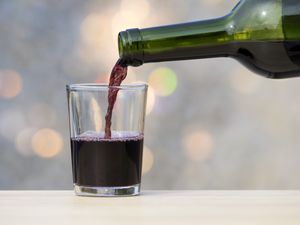 red wine pouring in cup