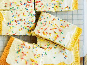 Strawberry Pop Tart Slab Pie Cut Into Slices on a Parchment Lined Cooling Rack