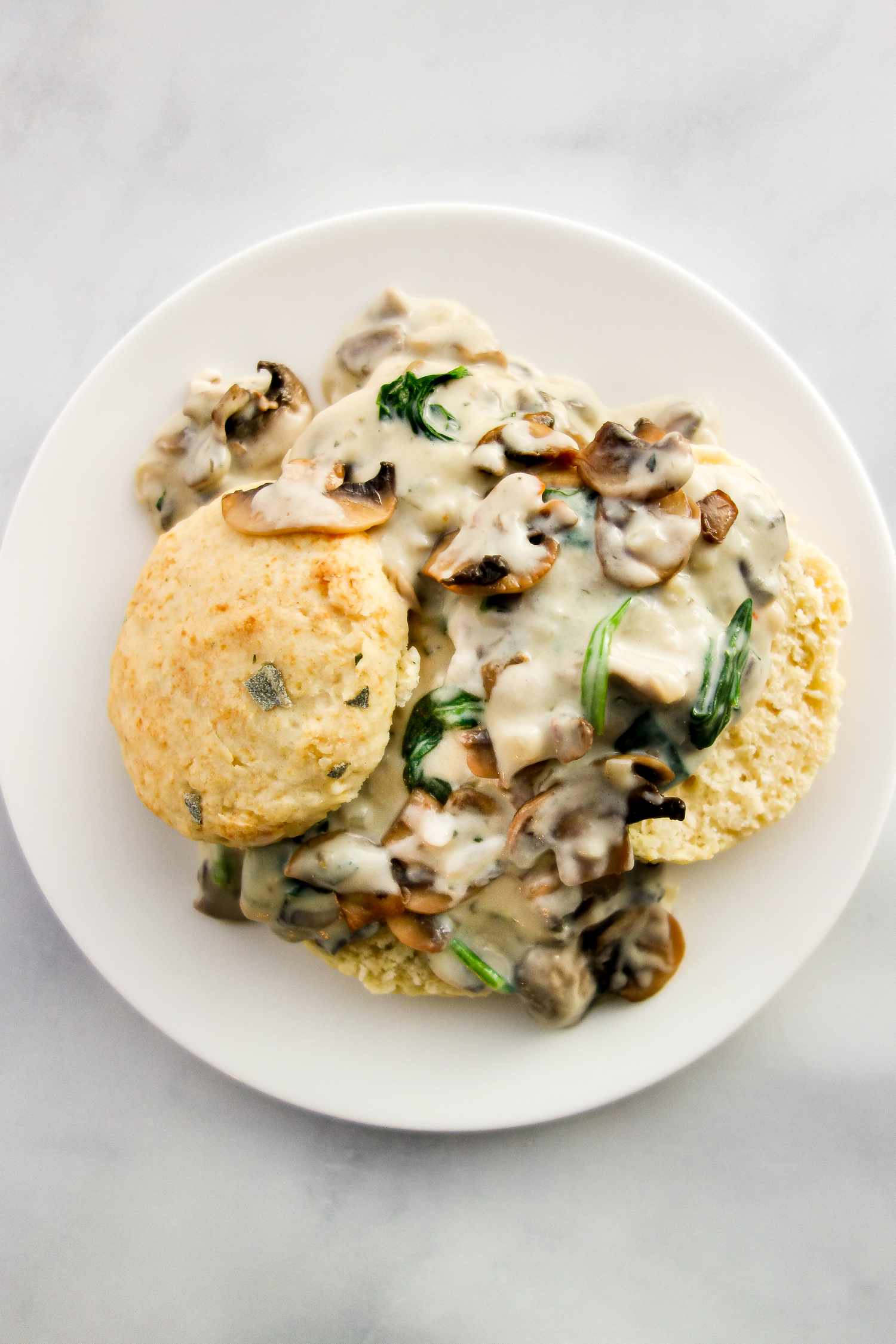 Vegetarian biscuits and gravy on a white plate.